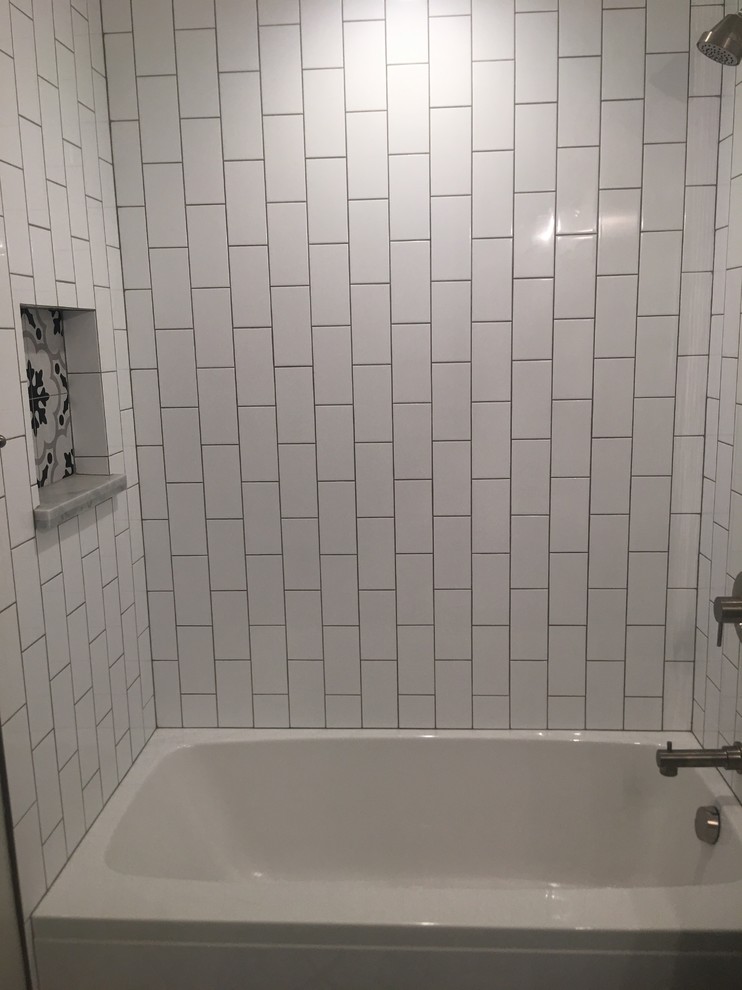 This is an example of a small midcentury family bathroom in Los Angeles with flat-panel cabinets, white cabinets, a built-in bath, a shower/bath combination, a one-piece toilet, white tiles, metro tiles, grey walls, cement flooring, an integrated sink, glass worktops, multi-coloured floors and a shower curtain.