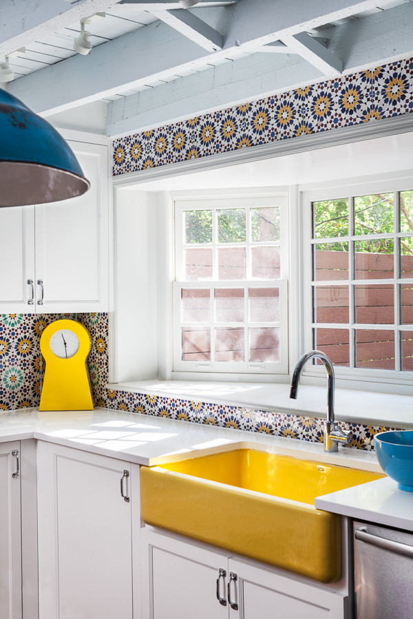 Photo of a large eclectic open plan kitchen in New York with a farmhouse sink, shaker cabinets, dark wood cabinets, quartzite benchtops, yellow splashback, mosaic tile splashback, stainless steel appliances, dark hardwood floors and with island.