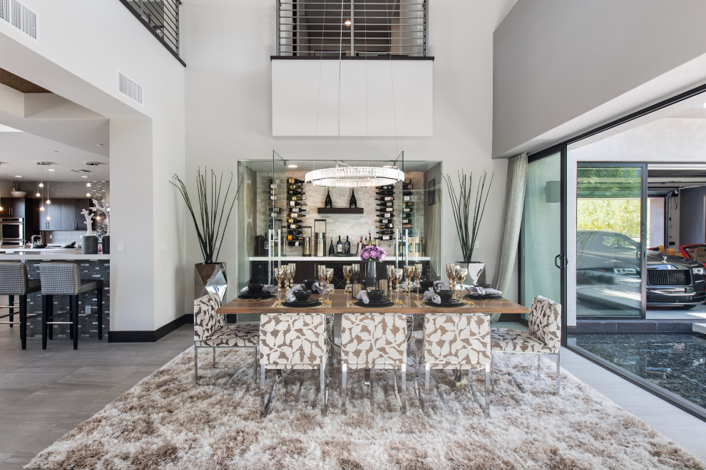Large contemporary kitchen/dining combo in Las Vegas with white walls and grey floor.