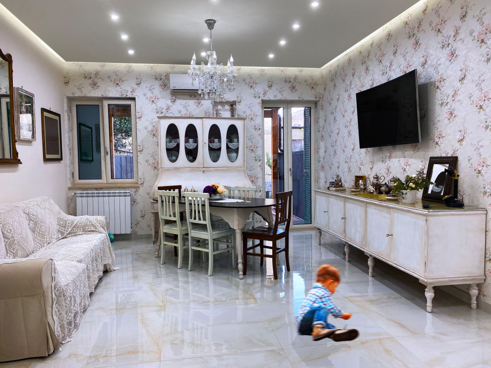 Inspiration for a small traditional open concept family room in Naples with white walls, porcelain floors, no fireplace, a wall-mounted tv, beige floor, recessed and wallpaper.
