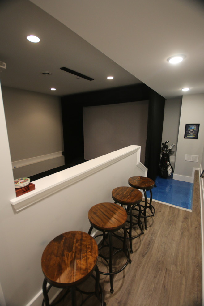 Inspiration for a mid-sized transitional look-out basement in Chicago with grey walls.