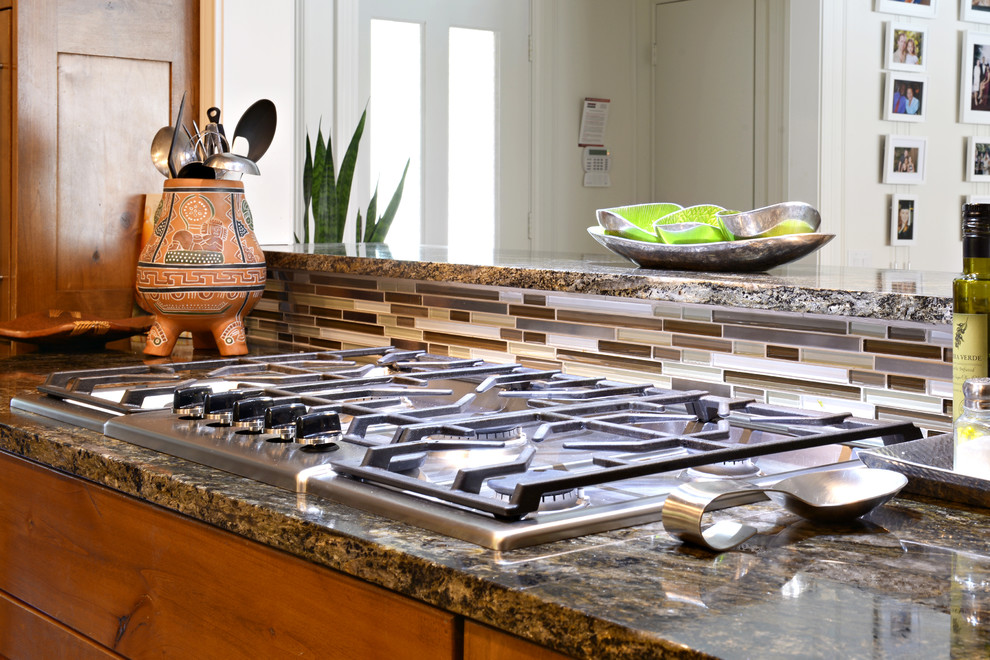 Inspiration for a large transitional u-shaped travertine floor eat-in kitchen remodel in Dallas with a farmhouse sink, medium tone wood cabinets, granite countertops, multicolored backsplash, matchstick tile backsplash, stainless steel appliances and a peninsula