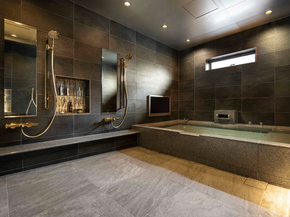 Photo of a bathroom with a hot tub, black walls, grey floor and recessed.