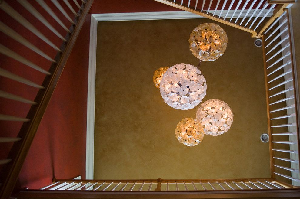 Foyer - large transitional light wood floor foyer idea with red walls