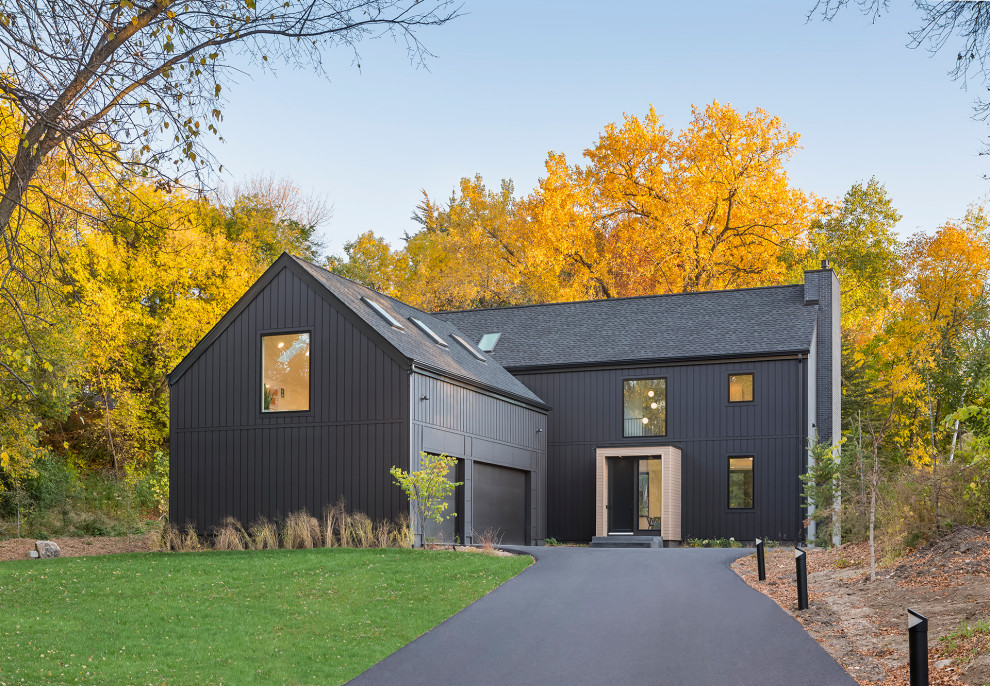 Large danish black two-story wood and board and batten exterior home photo in Minneapolis with a shingle roof and a black roof