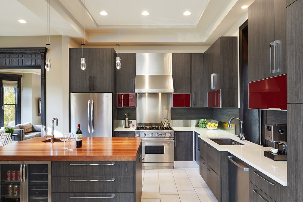 Design ideas for a contemporary l-shaped kitchen in Chicago with an undermount sink, flat-panel cabinets, dark wood cabinets, metallic splashback, stainless steel appliances, with island and white floor.