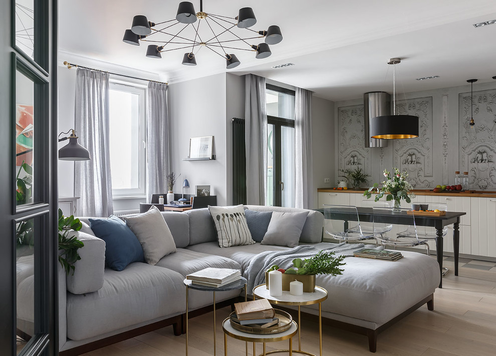 Photo of a contemporary open concept living room in Saint Petersburg with grey walls and light hardwood floors.