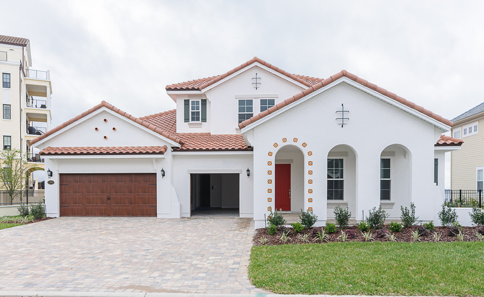 This is an example of a large mediterranean front door in Jacksonville with white walls, a single front door and a red front door.