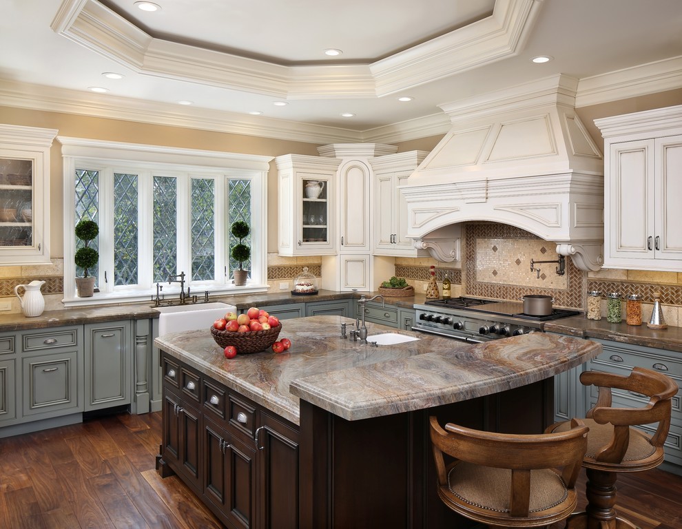 Photo of a large traditional l-shaped kitchen in San Francisco with a farmhouse sink, beaded inset cabinets, grey cabinets, beige splashback, stainless steel appliances, dark hardwood floors and with island.