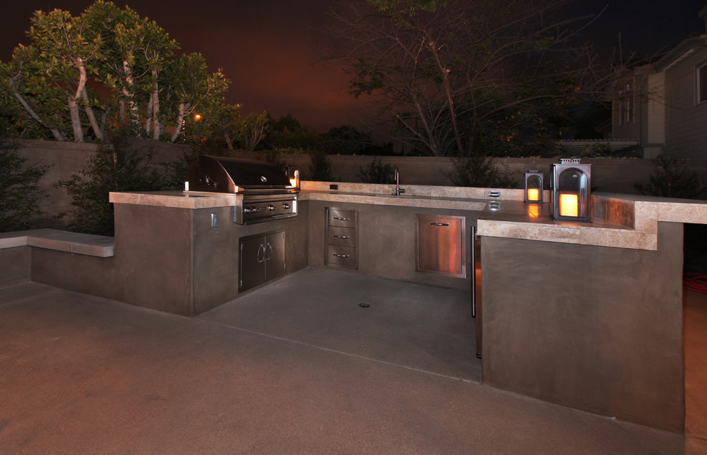 Design ideas for a small contemporary backyard patio in Orange County with an outdoor kitchen, stamped concrete and no cover.