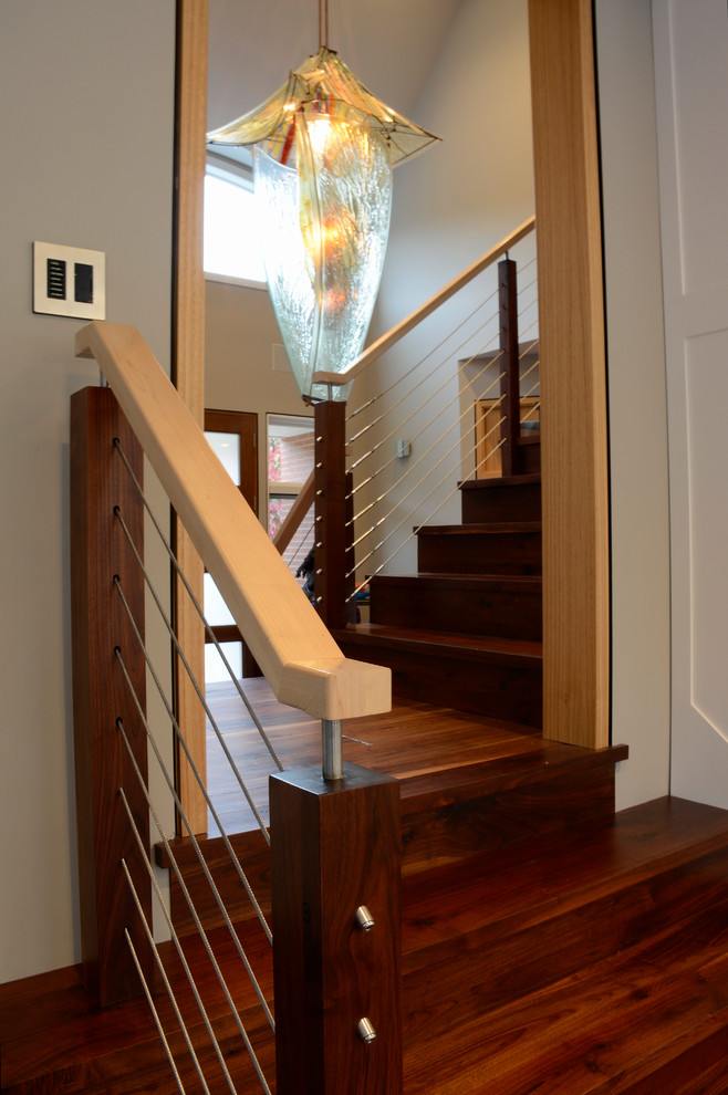 Staircase - large modern wooden l-shaped cable railing staircase idea in Philadelphia with wooden risers