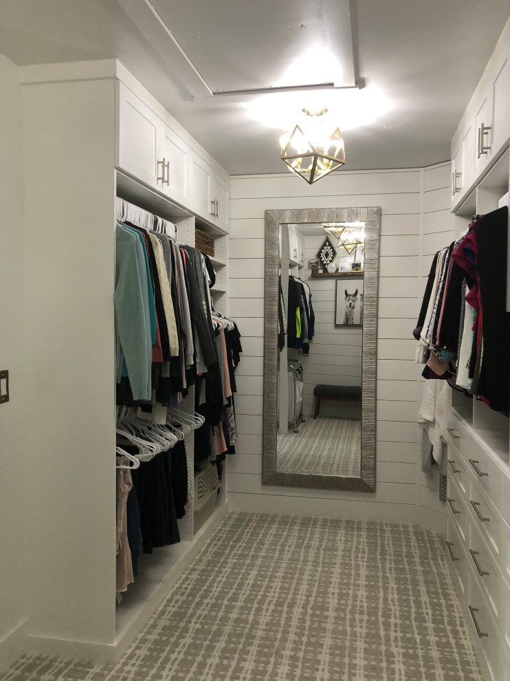 Design ideas for a mid-sized country gender-neutral walk-in wardrobe in Other with shaker cabinets, white cabinets, carpet and white floor.
