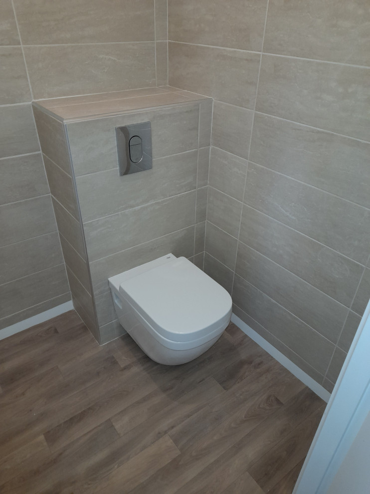 Design ideas for a large modern powder room in Nantes with a wall-mount toilet, beige tile and ceramic tile.