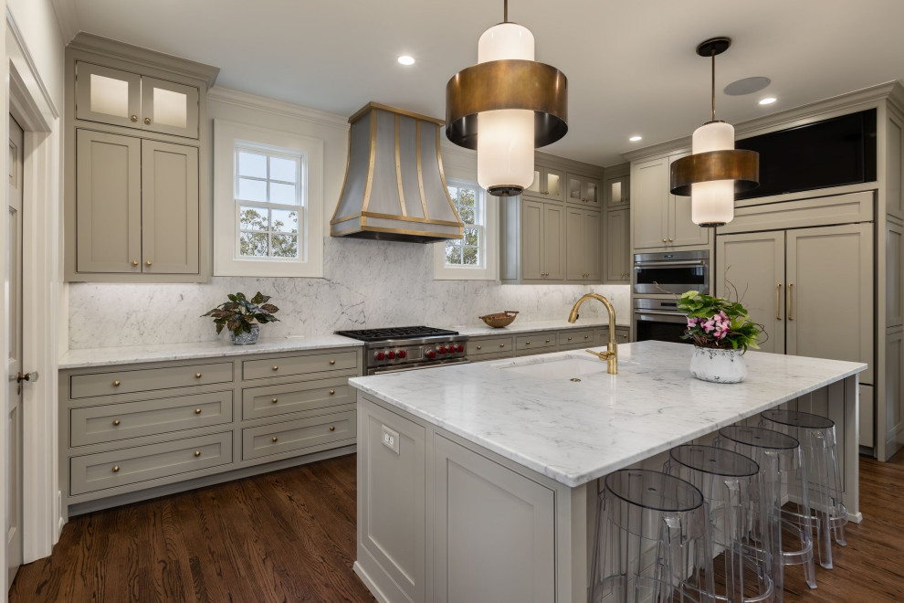 Example of a mid-sized transitional l-shaped medium tone wood floor and brown floor kitchen design with an undermount sink, gray cabinets, quartz countertops, white backsplash, quartz backsplash, paneled appliances, an island, white countertops and beaded inset cabinets