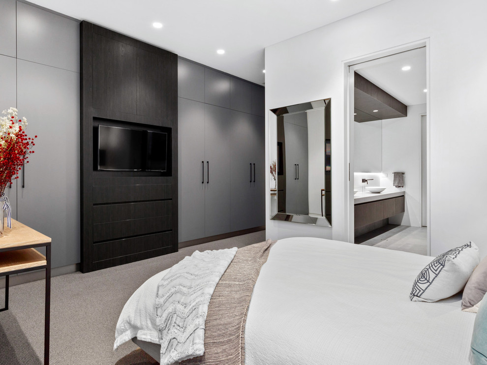 This is an example of a contemporary master bedroom in Perth with white walls, carpet, no fireplace and grey floor.