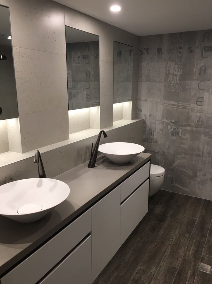 Inspiration for a large industrial master bathroom in Sydney with flat-panel cabinets, white cabinets, an open shower, a one-piece toilet, beige tile, stone slab, beige walls, porcelain floors, a vessel sink, an open shower, engineered quartz benchtops, brown floor, beige benchtops, a niche and a double vanity.