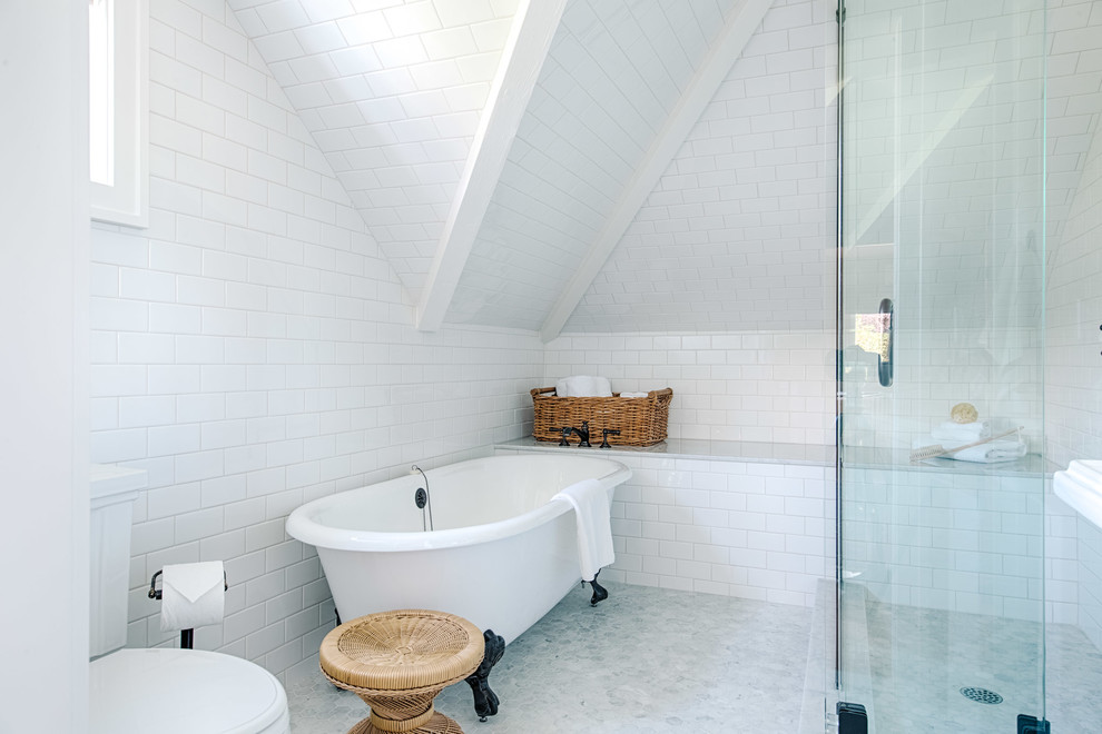 Country master bathroom in Seattle with a claw-foot tub, white tile, subway tile and white walls.