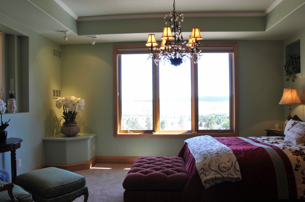 Mediterranean guest bedroom in Denver with green walls, carpet and beige floor.
