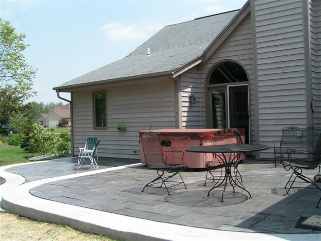 Inspiration for a mid-sized modern backyard patio in Milwaukee with natural stone pavers and no cover.