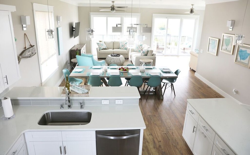 Photo of a beach style open plan dining in Miami with beige walls, light hardwood floors and no fireplace.