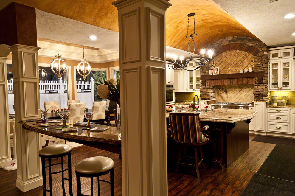 Inspiration for a large transitional u-shaped dark wood floor open concept kitchen remodel in Cleveland with beaded inset cabinets, white cabinets, granite countertops, beige backsplash, stainless steel appliances, metallic walls and an island