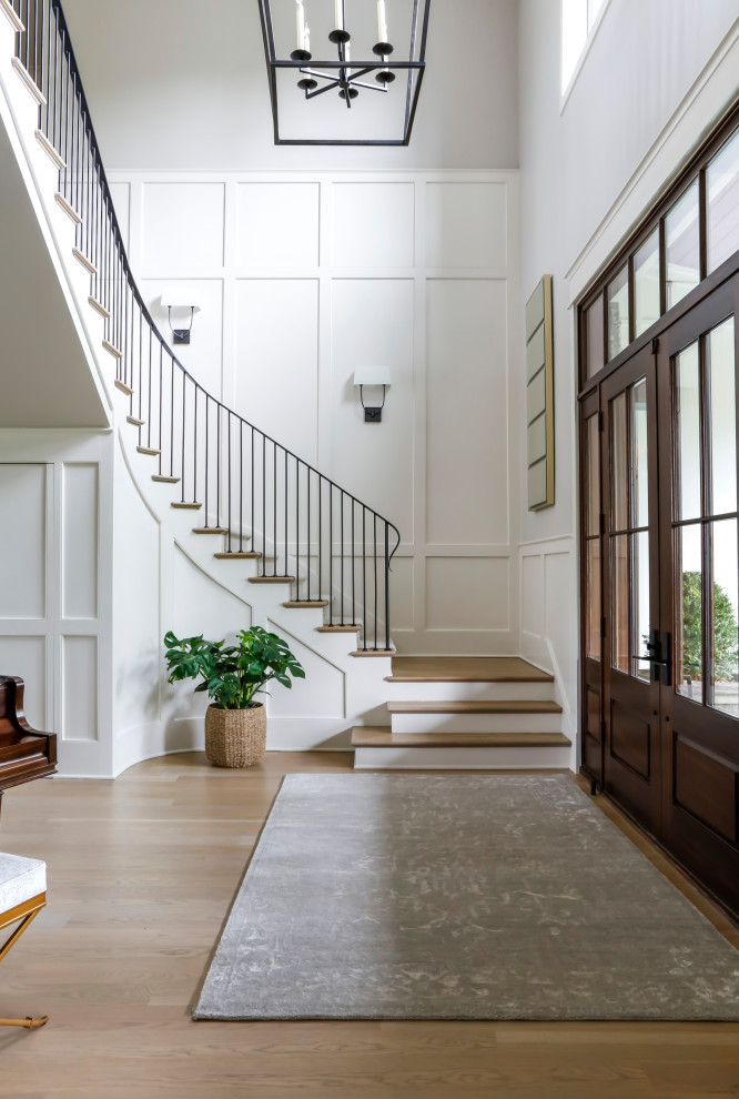 Inspiration for a large country foyer in Nashville with grey walls, medium hardwood floors, a double front door, a dark wood front door, brown floor and panelled walls.