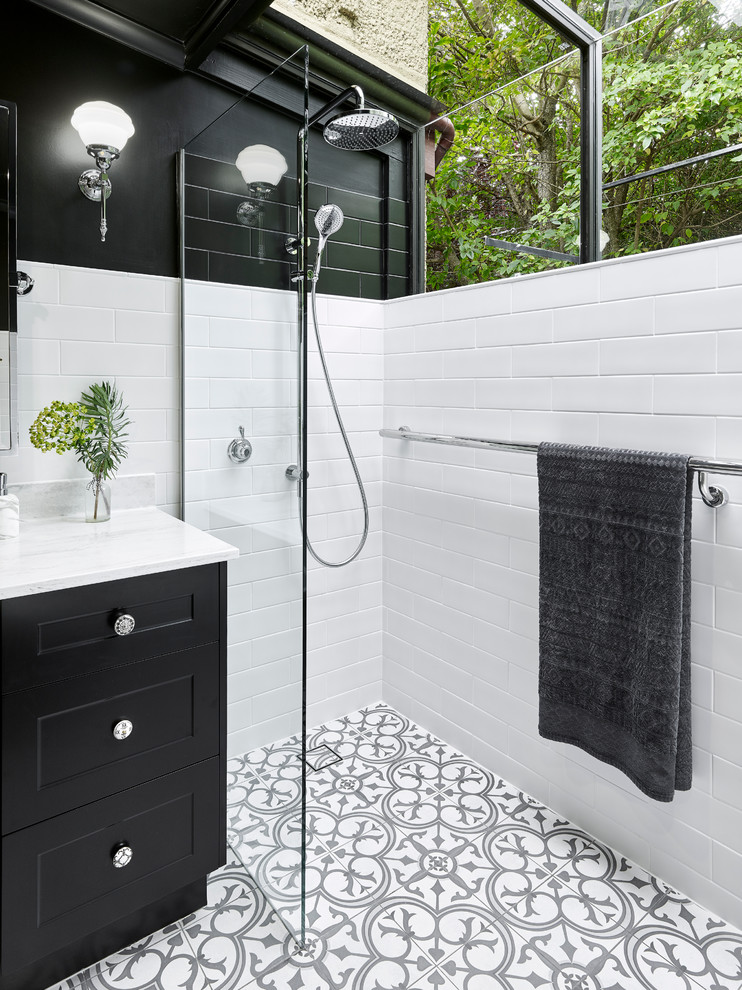 Design ideas for a mid-sized transitional master bathroom in Other with black cabinets, a drop-in tub, an open shower, black and white tile, white walls, porcelain floors, an undermount sink, solid surface benchtops, shaker cabinets, ceramic tile, multi-coloured floor, an open shower and white benchtops.