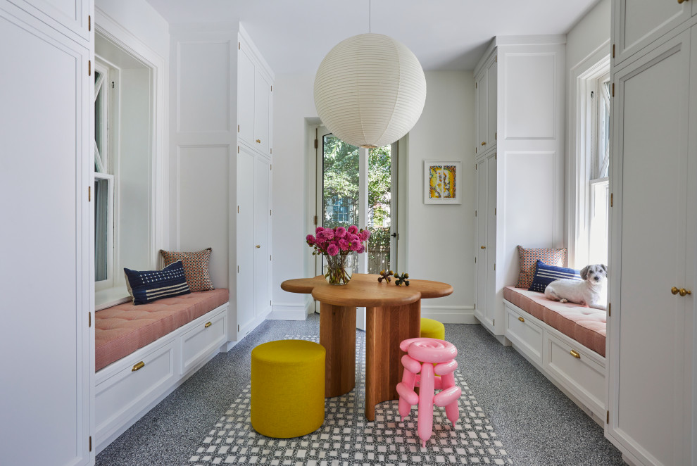This is an example of a large transitional mudroom in New York with white walls, marble floors and multi-coloured floor.