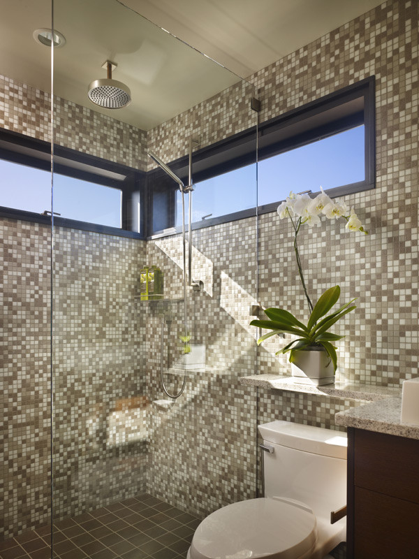 This is an example of a small modern bathroom in Seattle with flat-panel cabinets, brown cabinets, a curbless shower, a one-piece toilet, beige tile, ceramic tile, beige walls, porcelain floors, an undermount sink, granite benchtops, green floor, an open shower and beige benchtops.