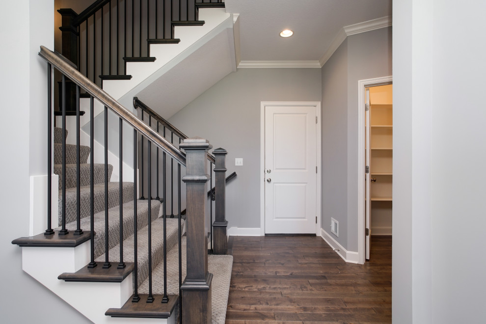 Design ideas for a mid-sized arts and crafts carpeted u-shaped staircase in Kansas City with carpet risers and metal railing.