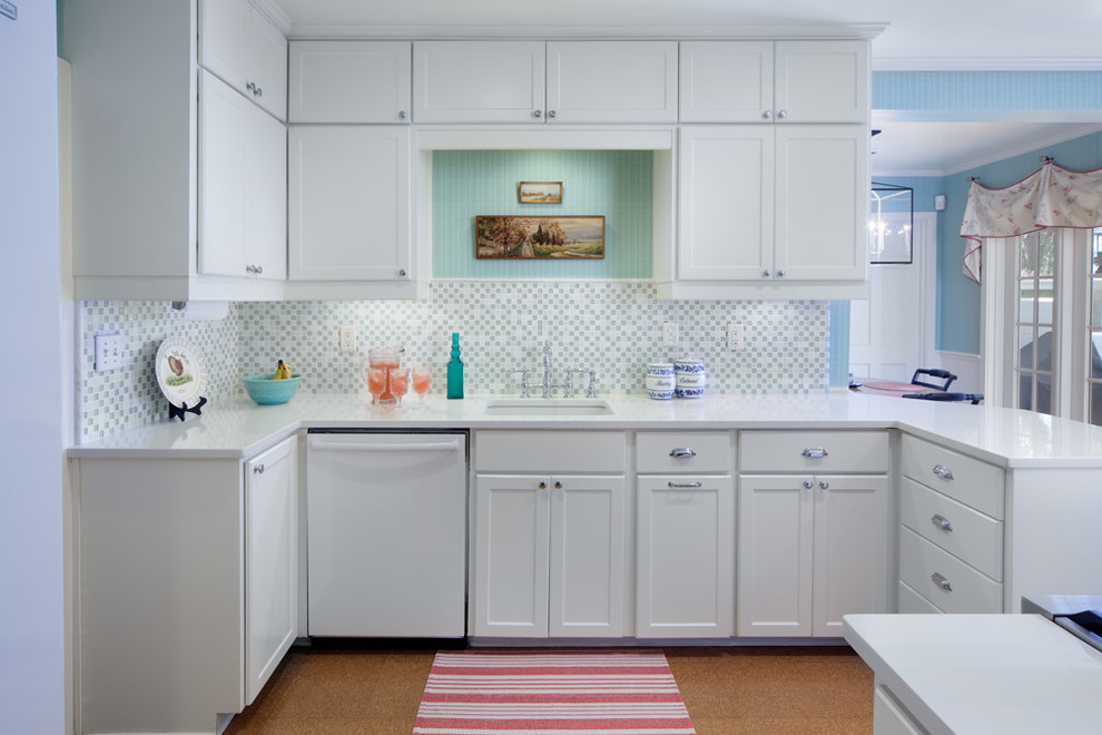Photo of a large traditional u-shaped eat-in kitchen in Orlando with an undermount sink, recessed-panel cabinets, white cabinets, mosaic tile splashback, white appliances, quartzite benchtops, grey splashback, cork floors and with island.