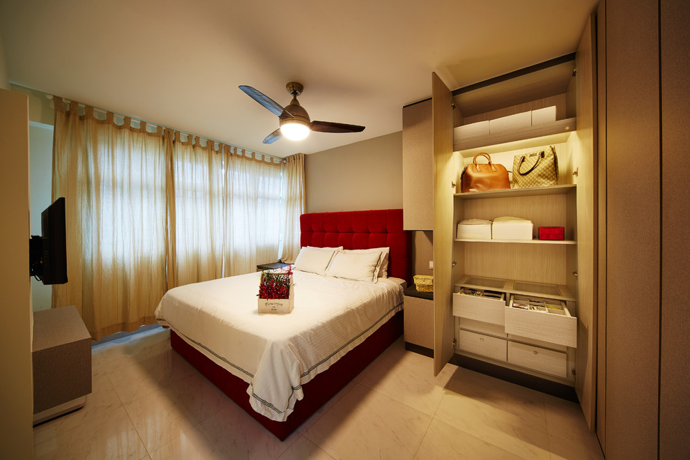 Photo of a mid-sized asian master bedroom in Singapore with beige walls and marble floors.