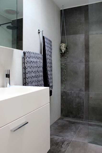 Design ideas for a mid-sized industrial master bathroom in Melbourne with white cabinets, an open shower, a one-piece toilet, gray tile, cement tile, white walls, cement tiles and a vessel sink.