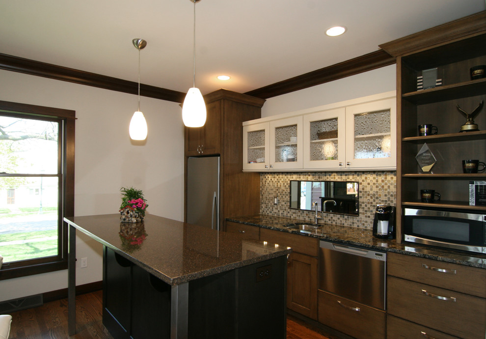 Design ideas for a mid-sized traditional galley eat-in kitchen in Grand Rapids with medium hardwood floors, an undermount sink, shaker cabinets, dark wood cabinets, granite benchtops, stainless steel appliances and with island.