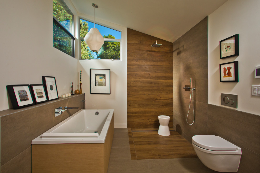 This is an example of a contemporary master bathroom in Other with a freestanding tub, a curbless shower, a wall-mount toilet, porcelain tile, white walls, porcelain floors, an open shower, brown tile and brown floor.