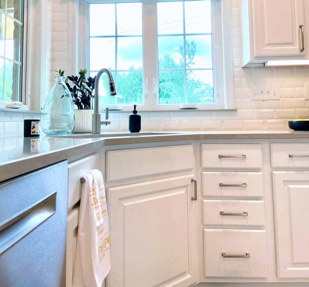 Open concept kitchen - large transitional u-shaped ceramic tile and beige floor open concept kitchen idea with an undermount sink, recessed-panel cabinets, white cabinets, quartz countertops, white backsplash, ceramic backsplash, stainless steel appliances, an island and gray countertops