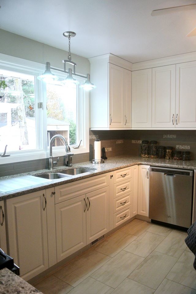 Transitional u-shaped separate kitchen in Ottawa with raised-panel cabinets, white cabinets, quartz benchtops, beige splashback, stainless steel appliances, ceramic floors and no island.