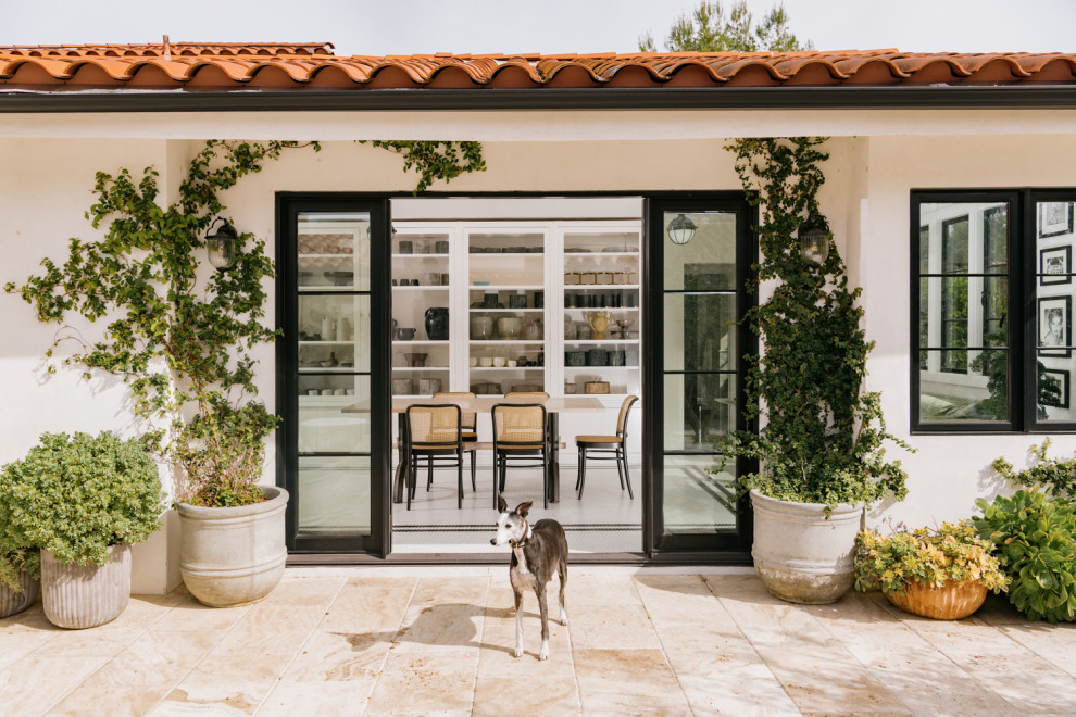 Inspiration for a large mediterranean back patio in Los Angeles with tiled flooring and no cover.