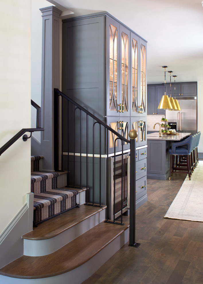 Inspiration for a large transitional hallway in Denver with white walls, medium hardwood floors and brown floor.