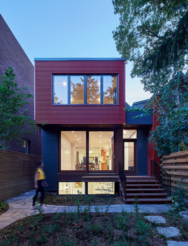На фото: двухэтажный, красный дом в современном стиле с облицовкой из металла с