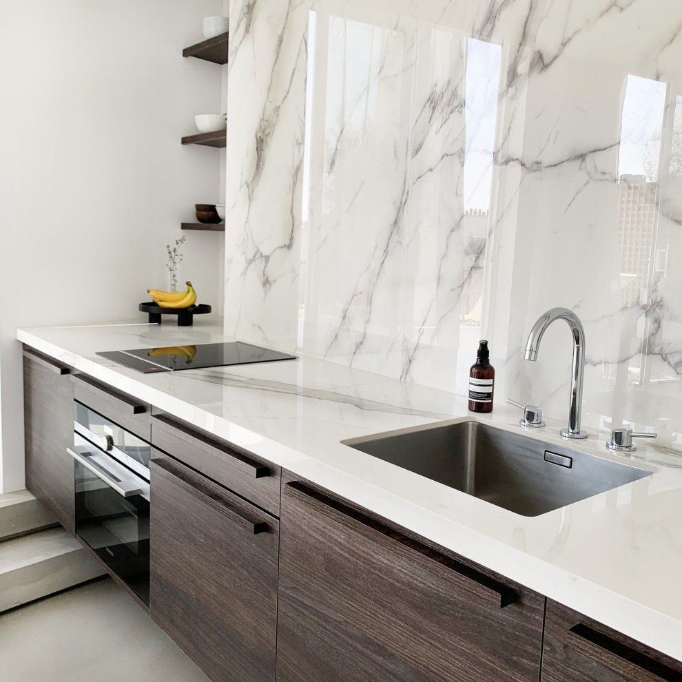 Foto di una cucina minimal con lavello sottopiano, ante in legno bruno, top piastrellato, paraspruzzi con piastrelle in ceramica, pavimento in cemento, pavimento grigio e top bianco