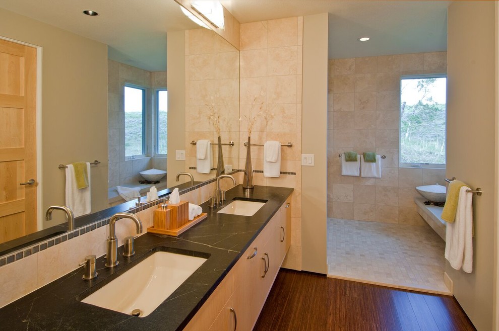 Design ideas for a mid-sized contemporary master bathroom in Denver with flat-panel cabinets, light wood cabinets, beige walls, an undermount sink, soapstone benchtops, an open shower, beige tile, porcelain tile, dark hardwood floors, brown floor and an open shower.