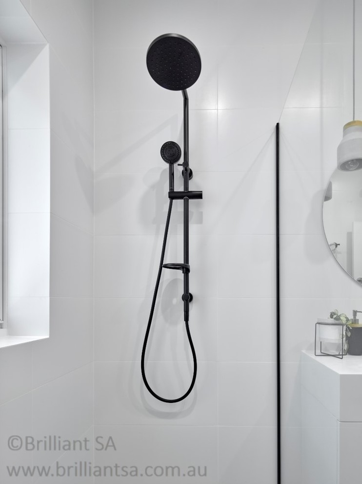 Design ideas for a mid-sized contemporary 3/4 bathroom in Adelaide with white cabinets, an open shower, a one-piece toilet, white walls, porcelain floors, a drop-in sink, grey floor, an open shower, flat-panel cabinets, white tile, ceramic tile, quartzite benchtops and white benchtops.