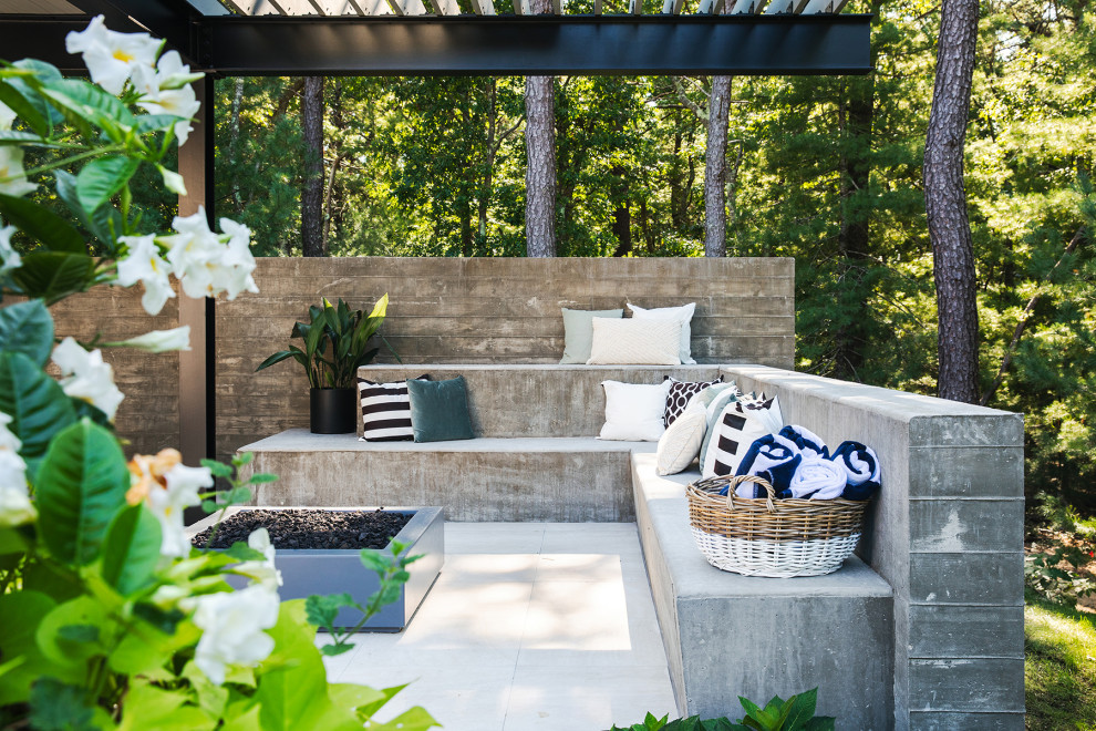 This is an example of a small contemporary side patio in New York with natural stone paving and a gazebo.