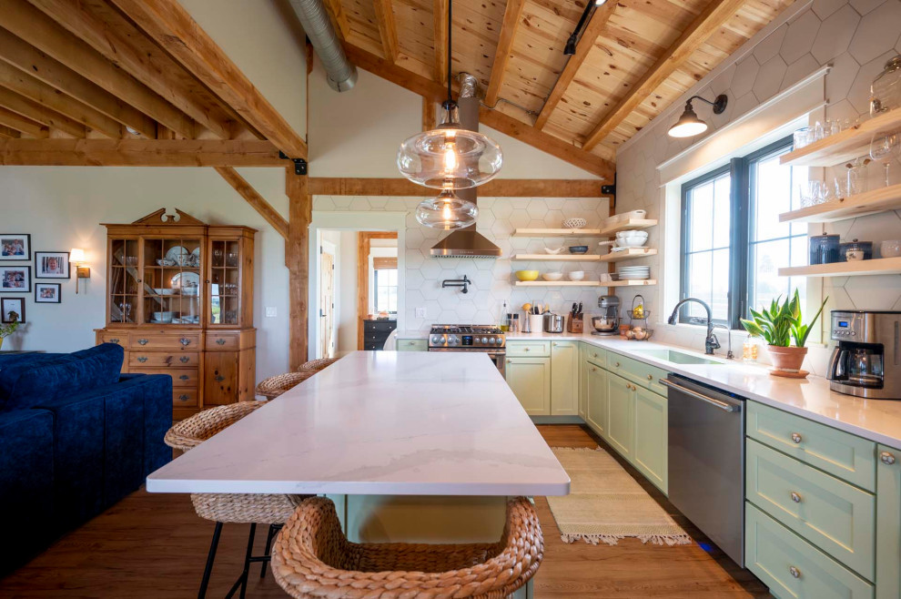 Mid-sized mountain style l-shaped light wood floor, brown floor and vaulted ceiling open concept kitchen photo with a farmhouse sink, granite countertops, white backsplash, stainless steel appliances, an island and white countertops