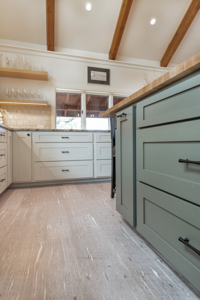 Inspiration for a mid-sized transitional u-shaped vaulted ceiling eat-in kitchen remodel with shaker cabinets, green cabinets, granite countertops, beige backsplash, ceramic backsplash, stainless steel appliances, an island and multicolored countertops