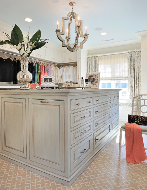 This is an example of a large transitional gender-neutral dressing room in Charlotte with raised-panel cabinets, distressed cabinets and carpet.