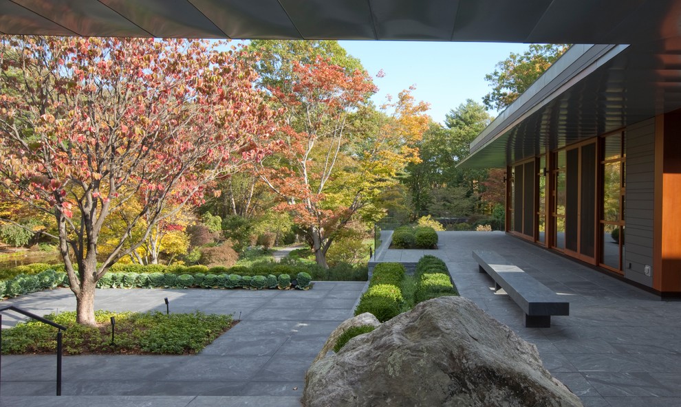 Patio - backyard stone patio idea in Boston