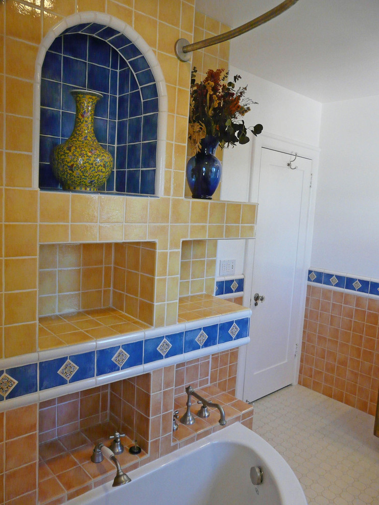 This is an example of a mid-sized master bathroom in San Diego with furniture-like cabinets, dark wood cabinets, a corner tub, a shower/bathtub combo, a one-piece toilet, yellow tile, ceramic tile, grey walls, ceramic floors, an undermount sink and tile benchtops.