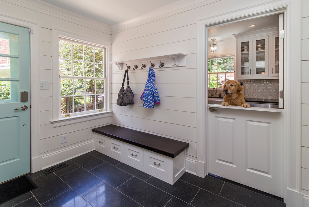 Photo of a country entryway in Charlotte with white walls and porcelain floors.